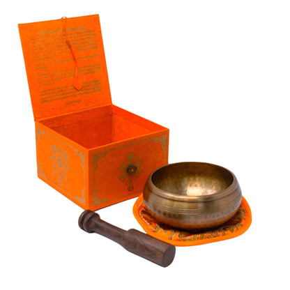 Set completo de cuenco tibetano con caja naranja, baqueta de madera y cojín bordado para meditación.