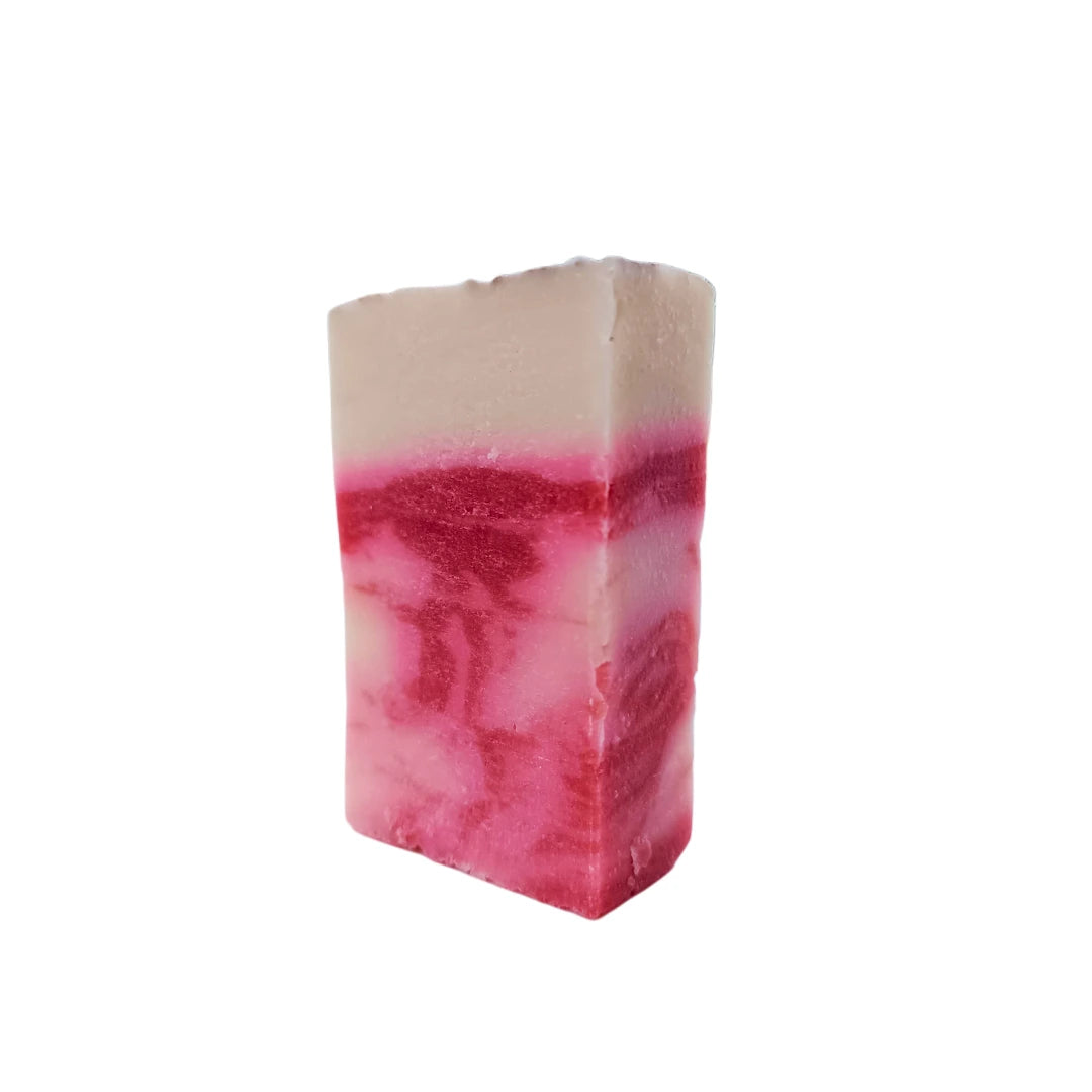 Jabón artesanal de arcilla roja en posición vertical con vetas rosadas y blancas, ideal para pieles con impurezas.