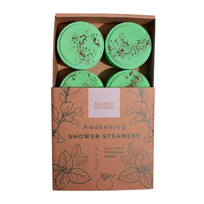 Caja de vaporizadores de ducha Despertar de Ancient Wisdom con cuatro discos verdes, elaborados con aceites esenciales de naranja, menta y eucalipto, presentados en envase kraft ecológico.