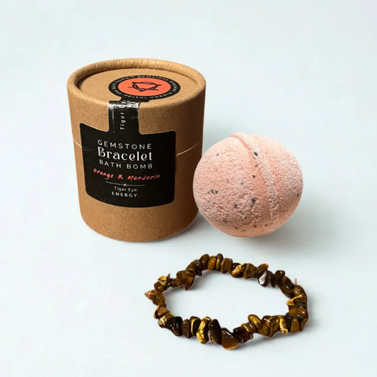 Bomba de baño energizante de naranja y mandarina con pulsera de ojo de tigre para fuerza y vitalidad.