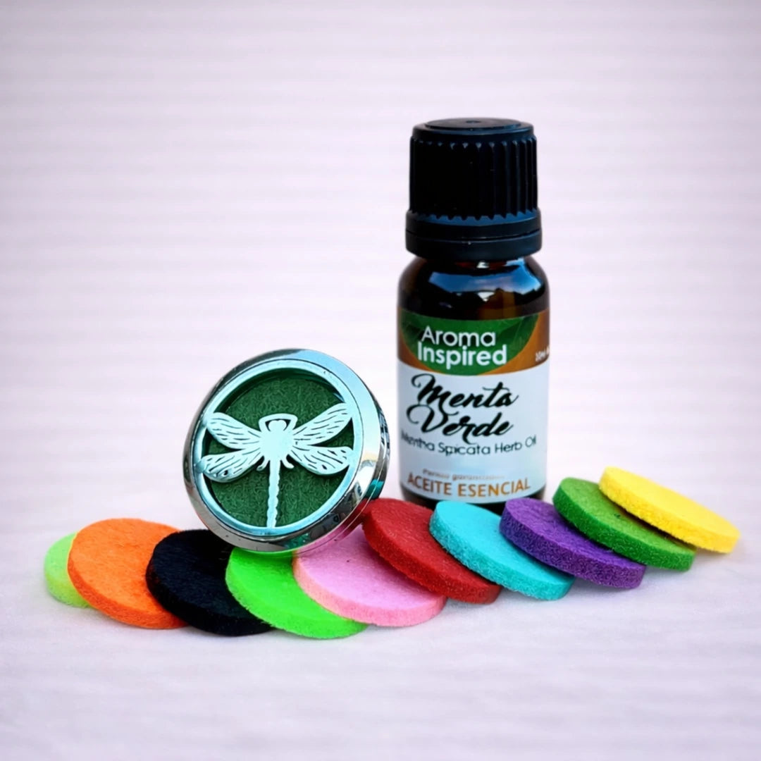 Difusor de aromas para coche con diseño de libélula más un aceite esencial de menta verde y discos de fieltro de colores sobre fondo neutro
