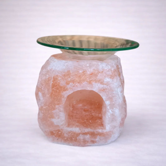 Quemador de aceites esenciales de sal del Himalaya con cuenco de cristal, fondo neutro claro